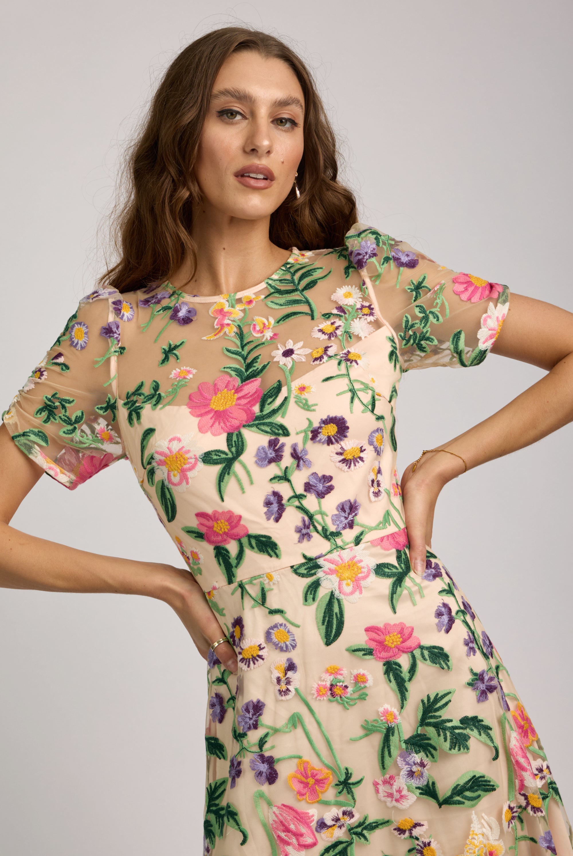 Woman wearing a floral dress with a plain background
