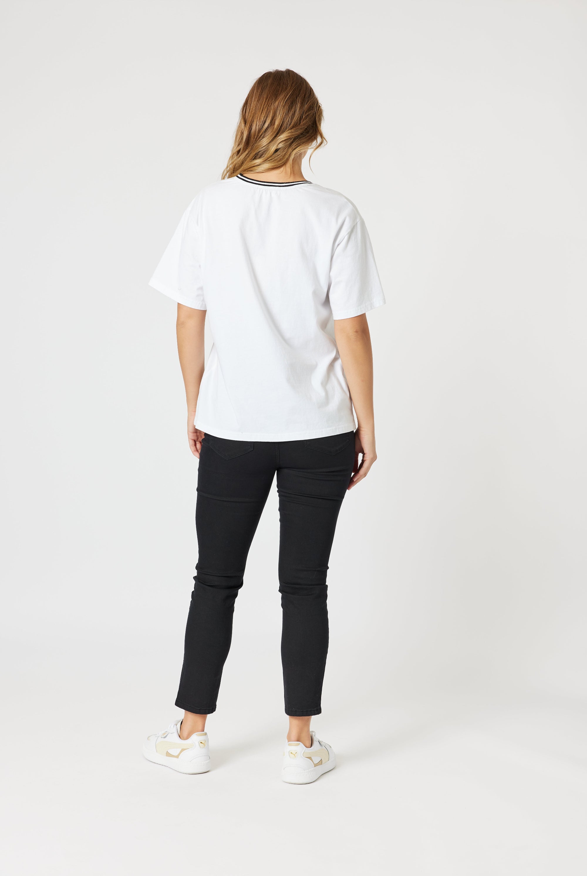 womens boxy white tee with embroidered le marais print worn by model back view