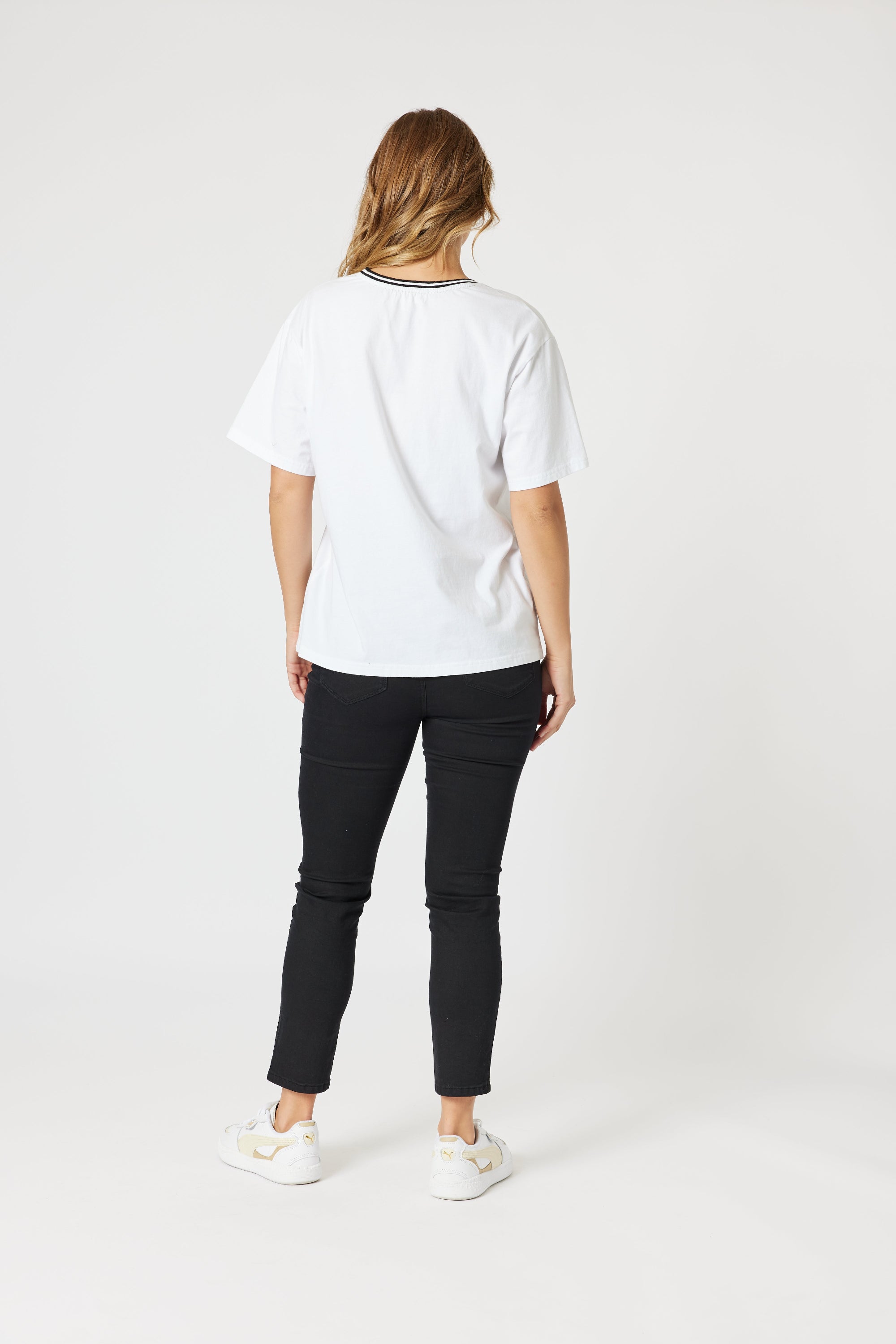womens boxy white tee with embroidered le marais print worn by model back view