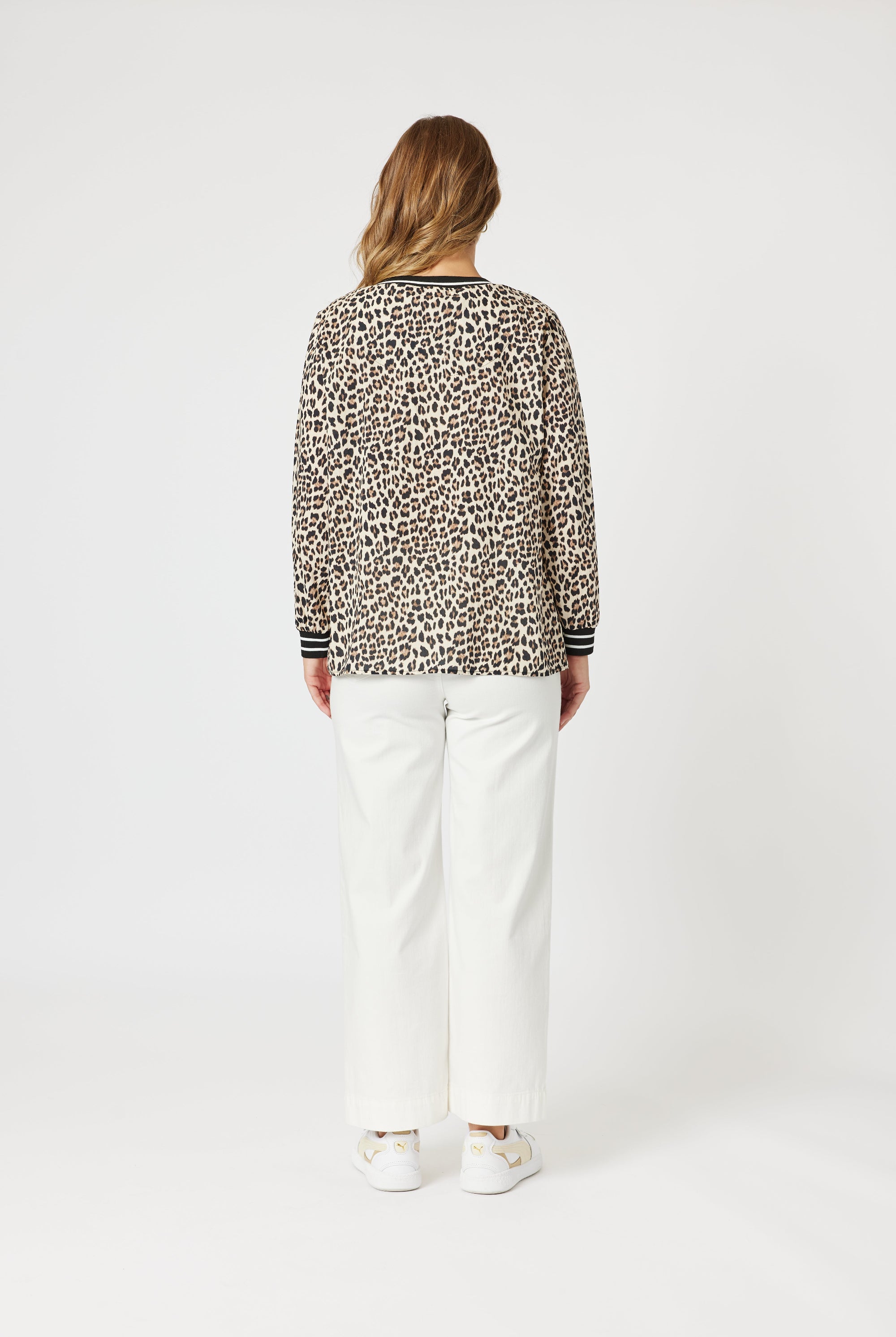 womens v neck leopard print top with black white contrast trims worn my model back view