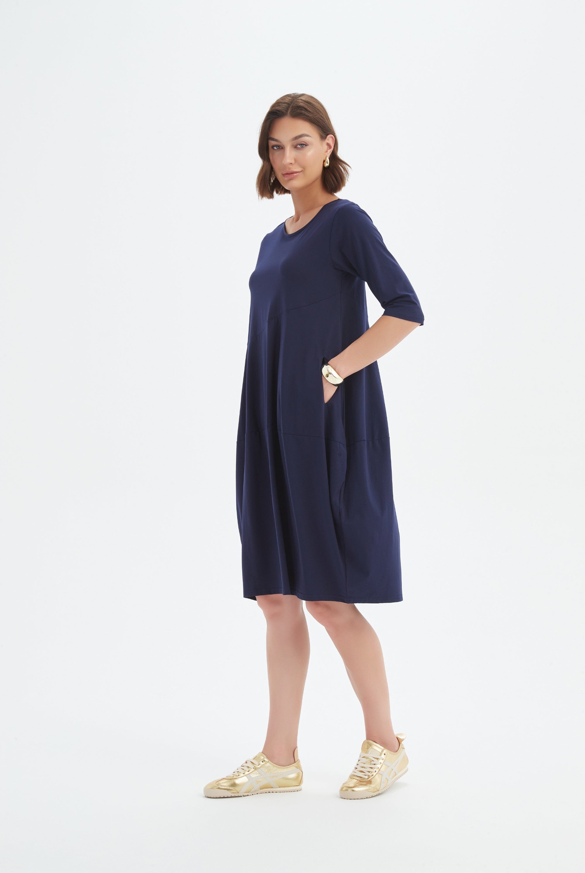 midi diagonal seam dress in navy worn by model
