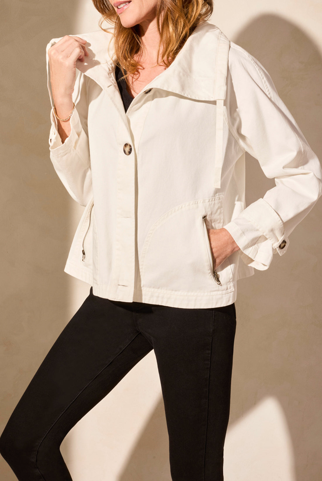 light coat jacket in white with black pants worn by model