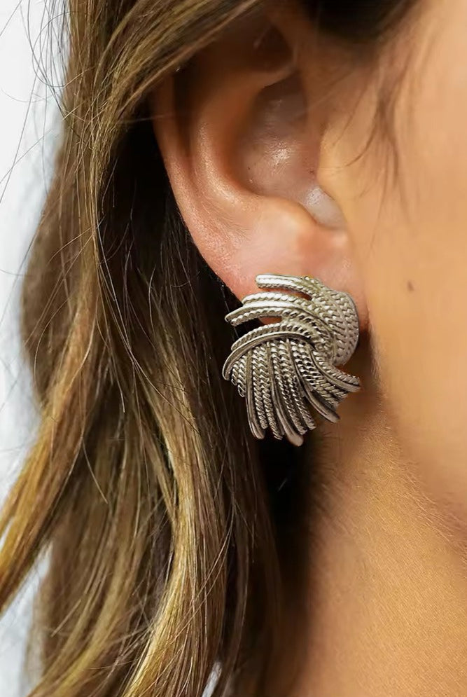 silver twist earrings on ear