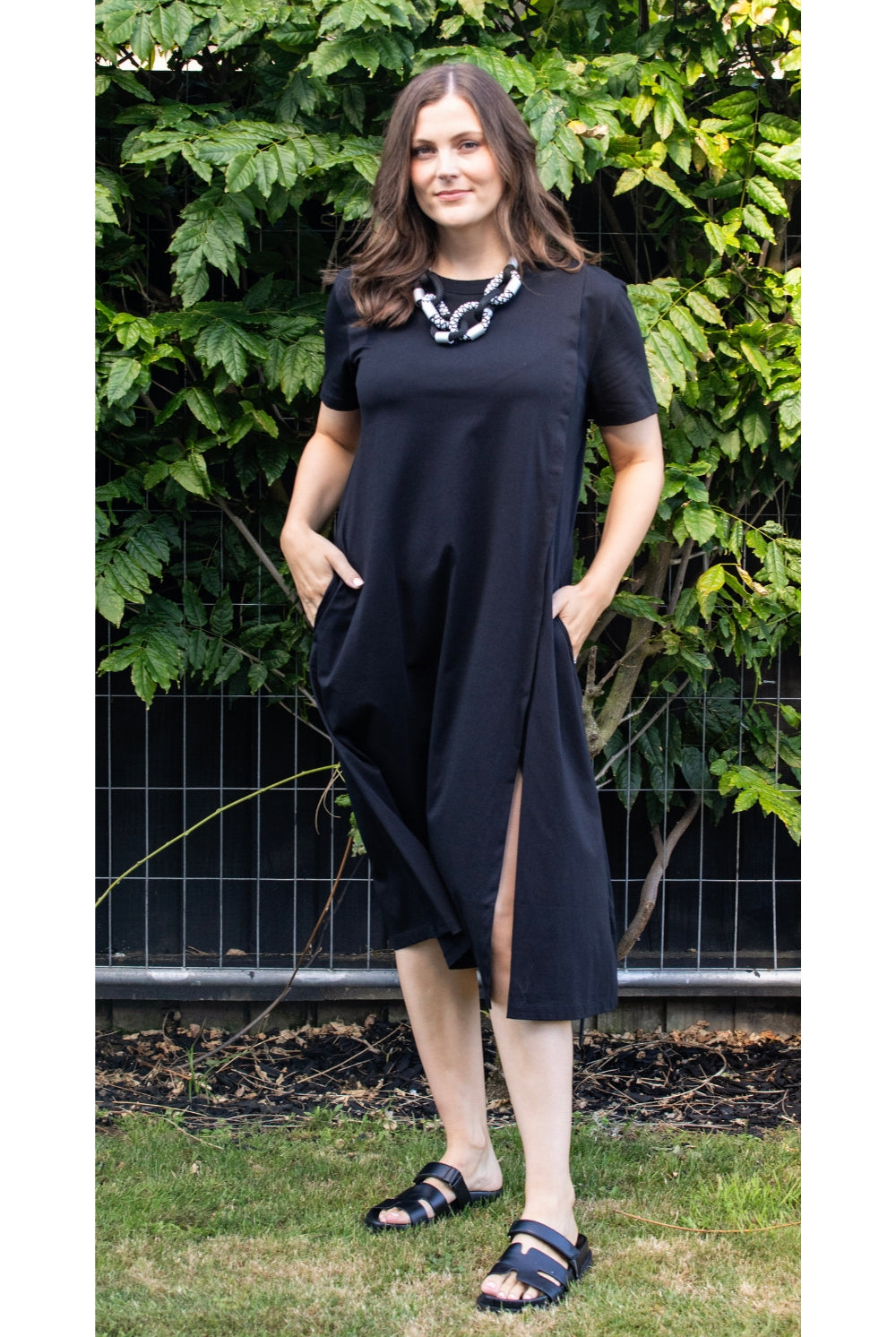 womens black midi dress with leg split worn by model