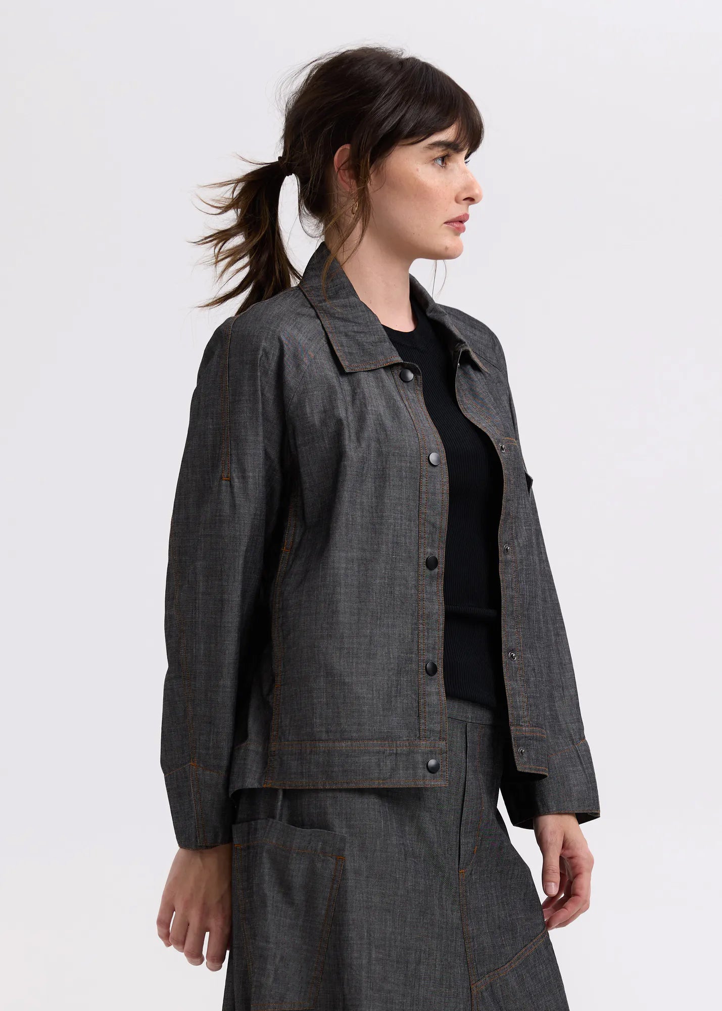 charcoal denim shaket worn by model on a white background