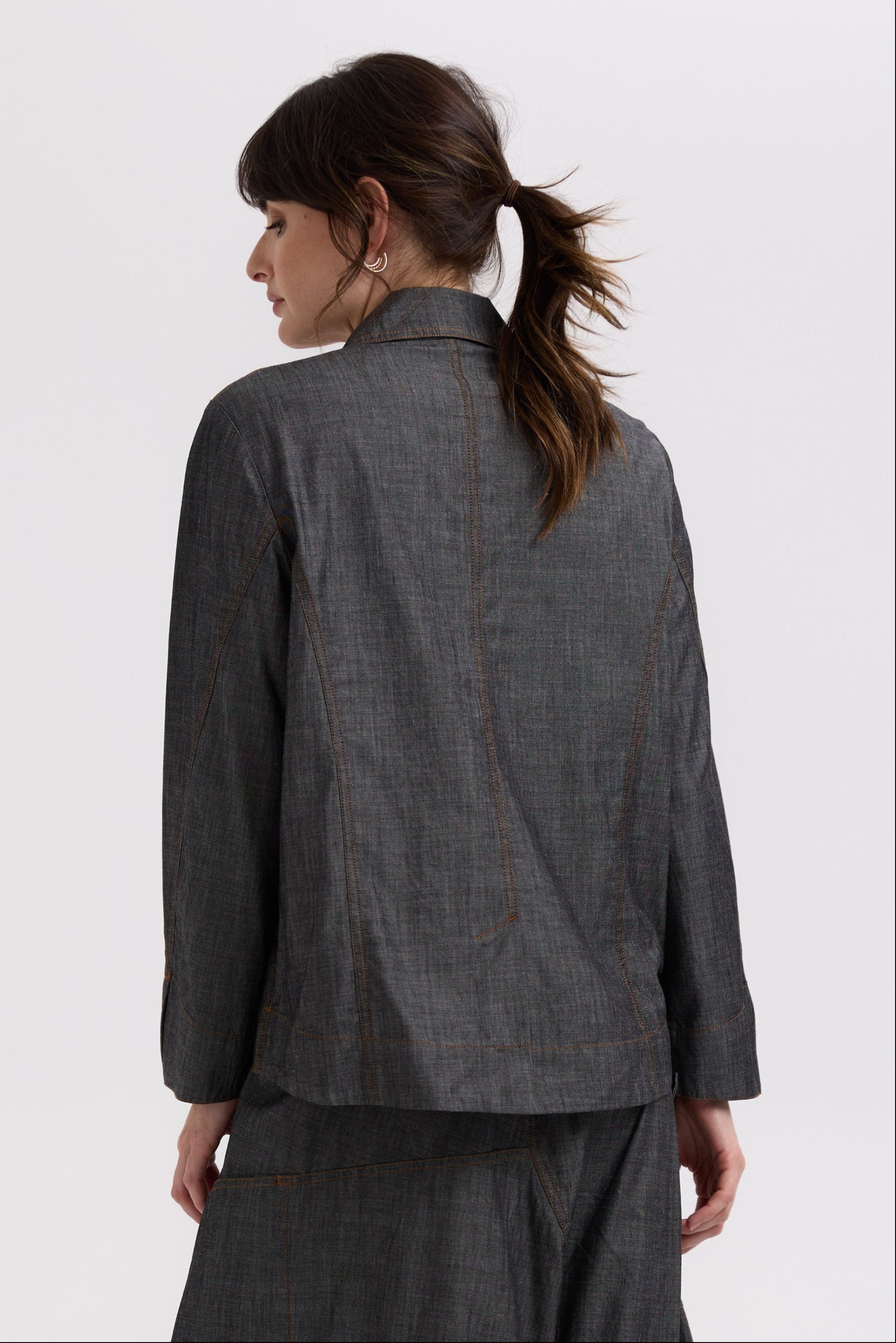 charcoal denim shaket worn by model on a white background back