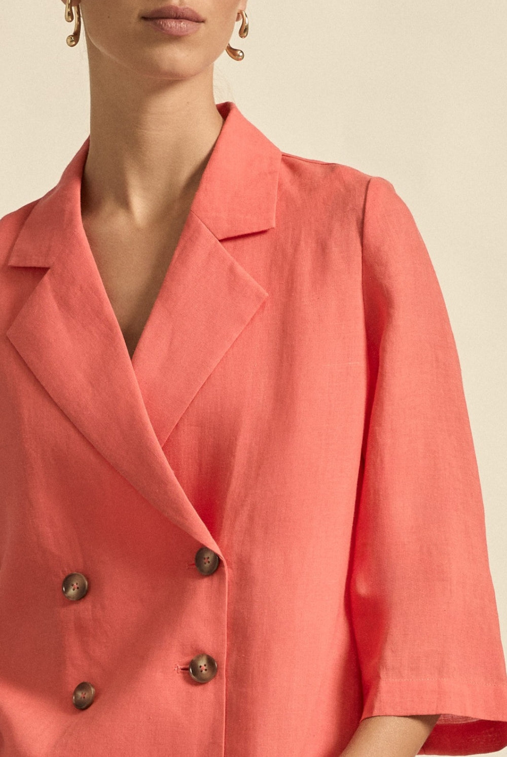 womens double breasted jacket in melon worn by model close up