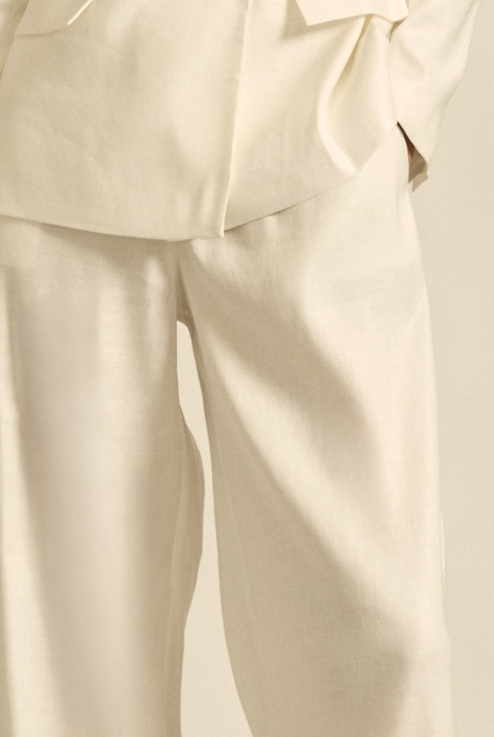 womens off white tailored relaxed pant worn by model close up