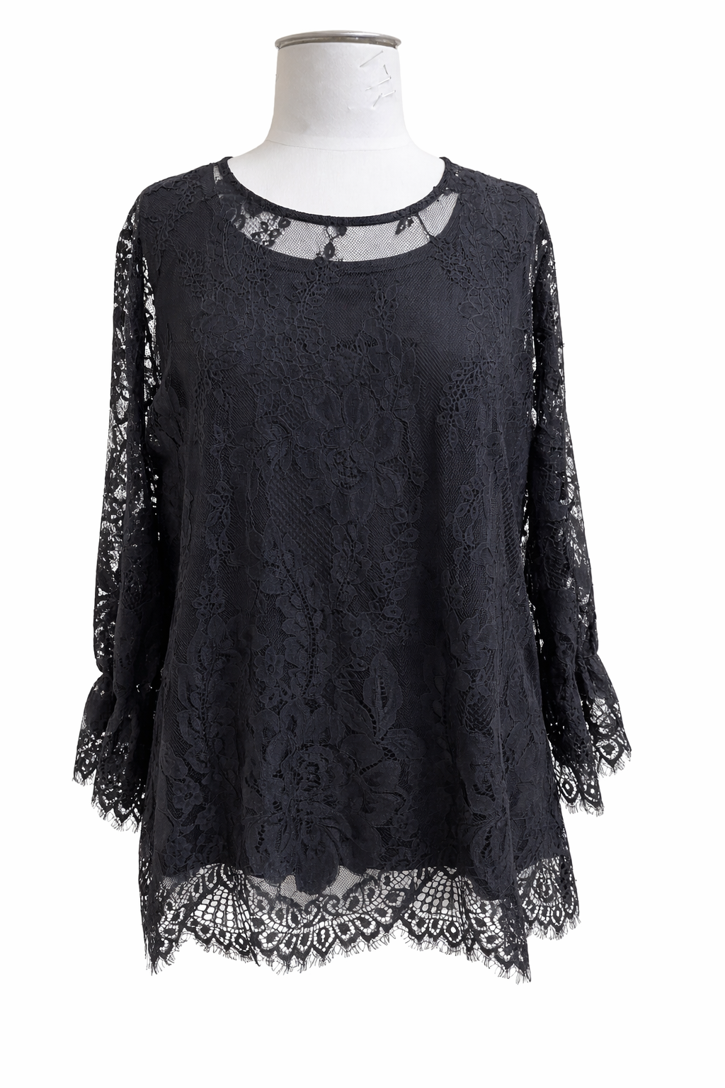 Black lace top on a mannequin against a white background
