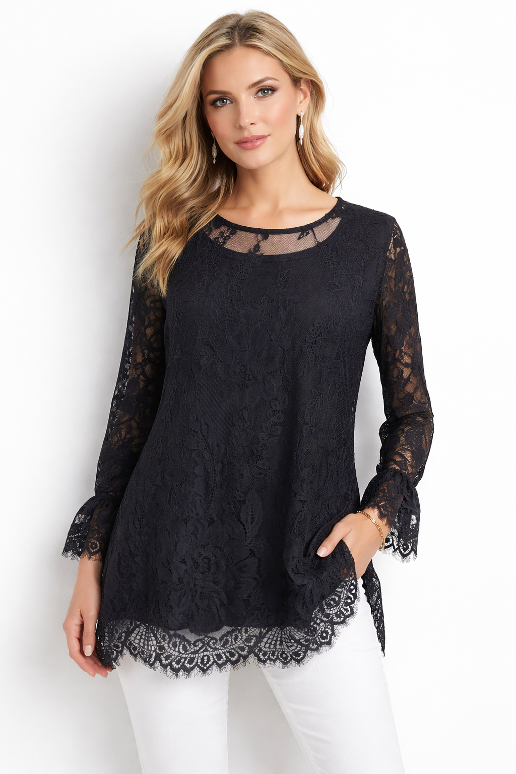 Woman wearing a black lace long-sleeve top against a white background