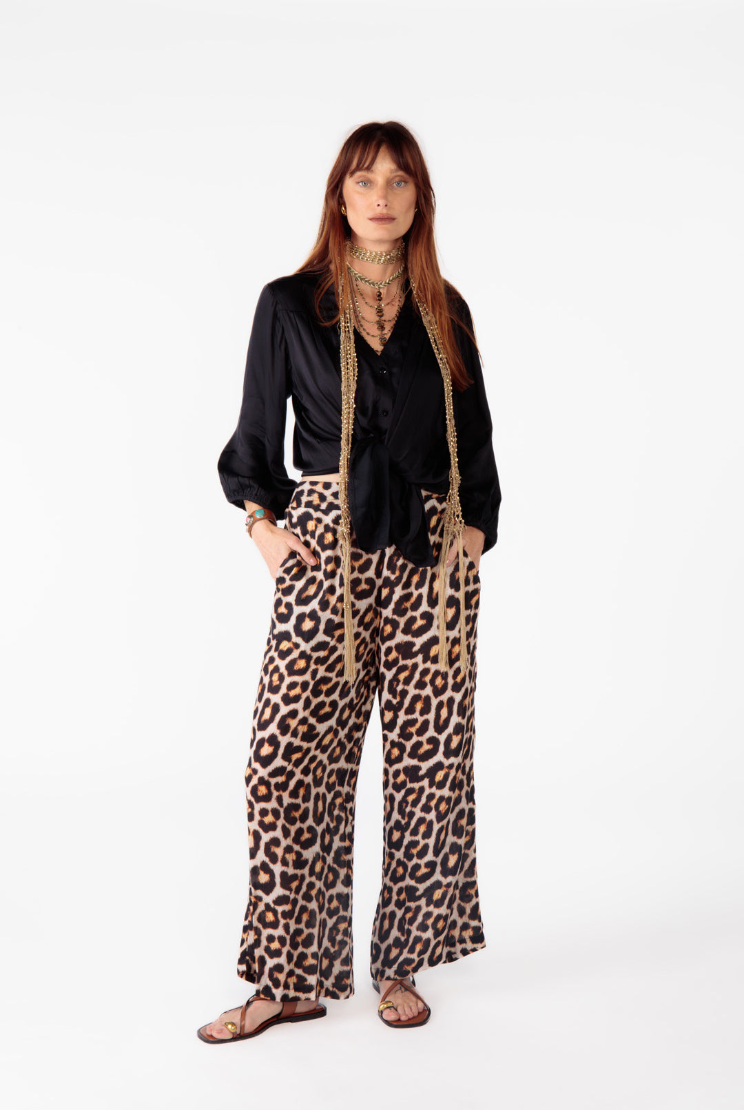 Black button-through shirt styled with leopard pants; woman poses in the Ruby Yaya Gabor Shirt by Ruby Yaya.