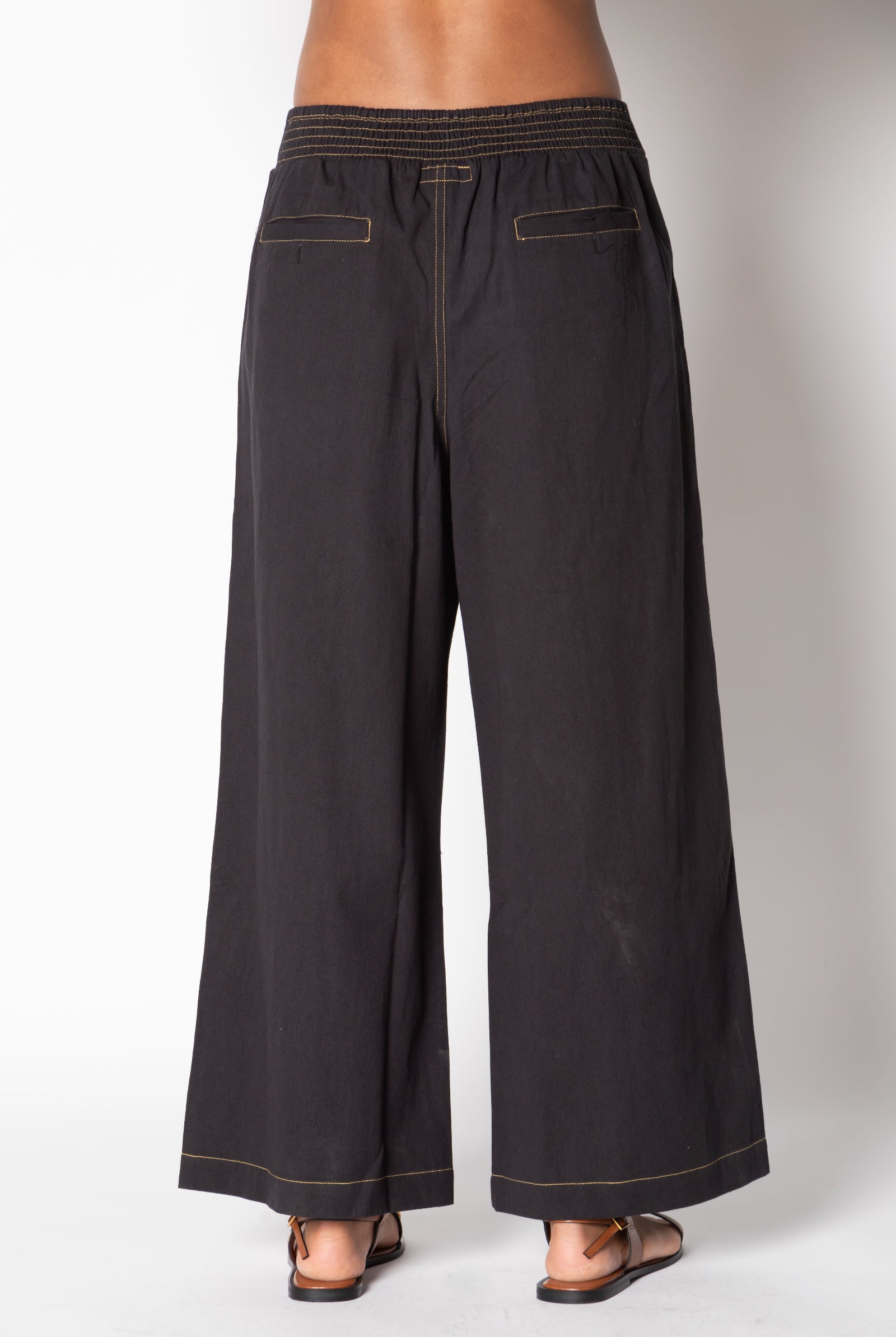 Back of black palazzo-style pants with elastic waistband and contrast-stitched pockets – Ruby Yaya Pula Pant