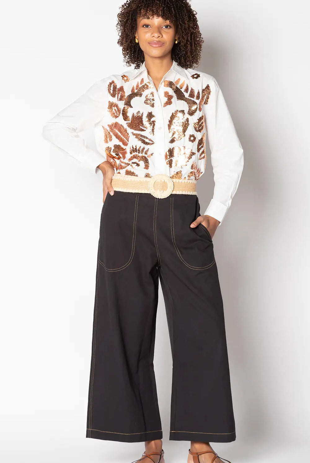 Model wearing black Ruby Yaya Pula Pant styled casually, showcasing wide-leg fit and 3/4 length design.