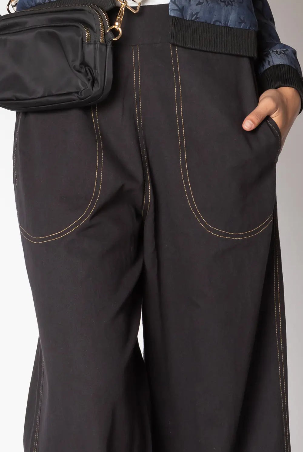 Close-up of side pocket and stitching detail on the black Ruby Yaya Pula Pant
