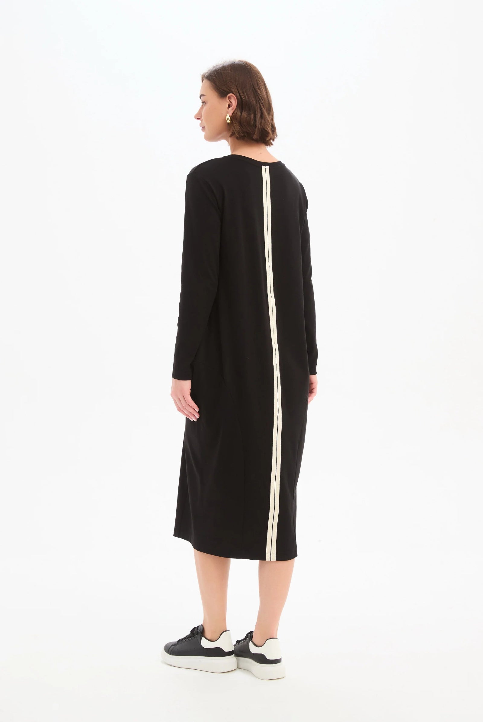 Black dress with a white stripe on a white background