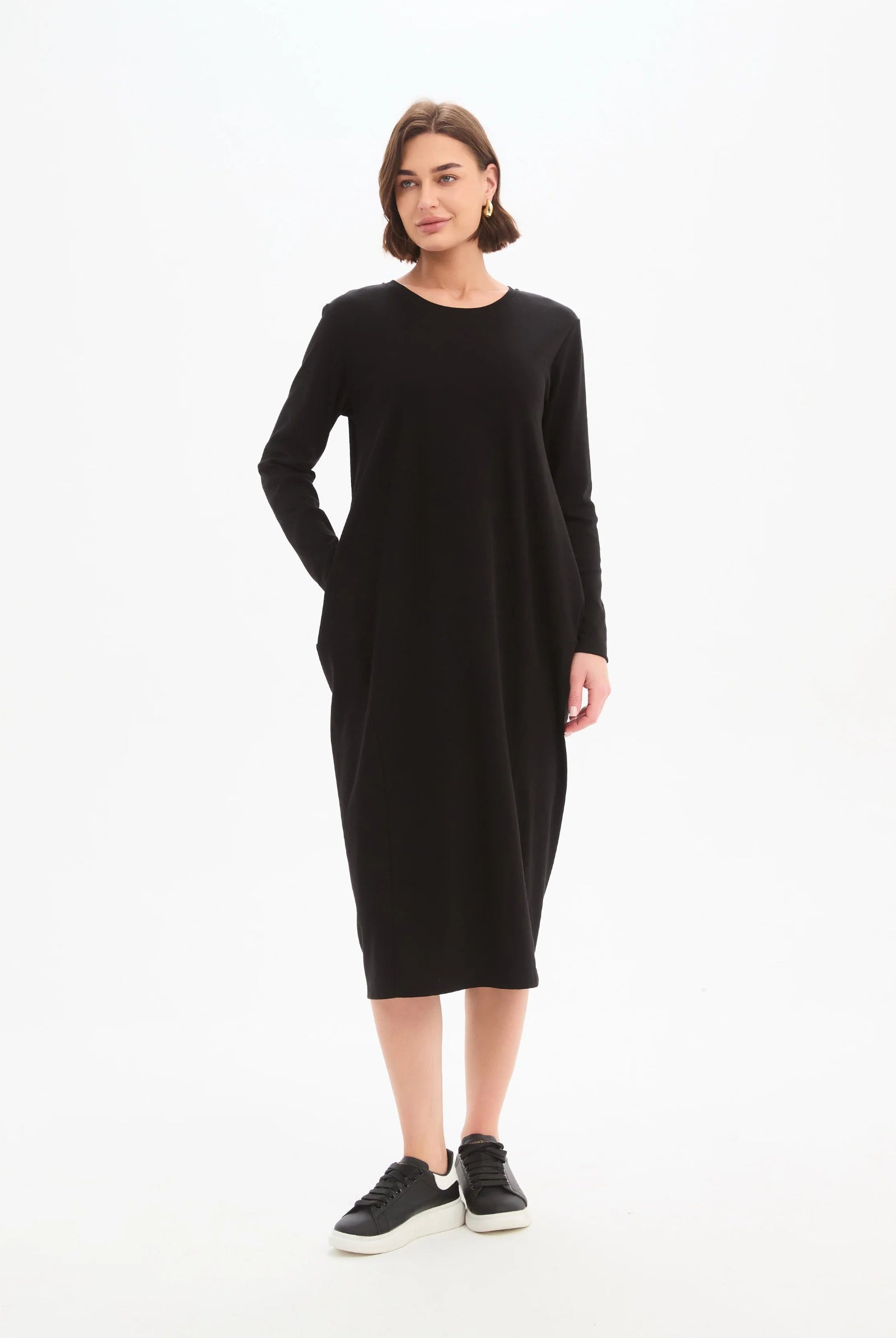 Woman wearing a black dress on a white background
