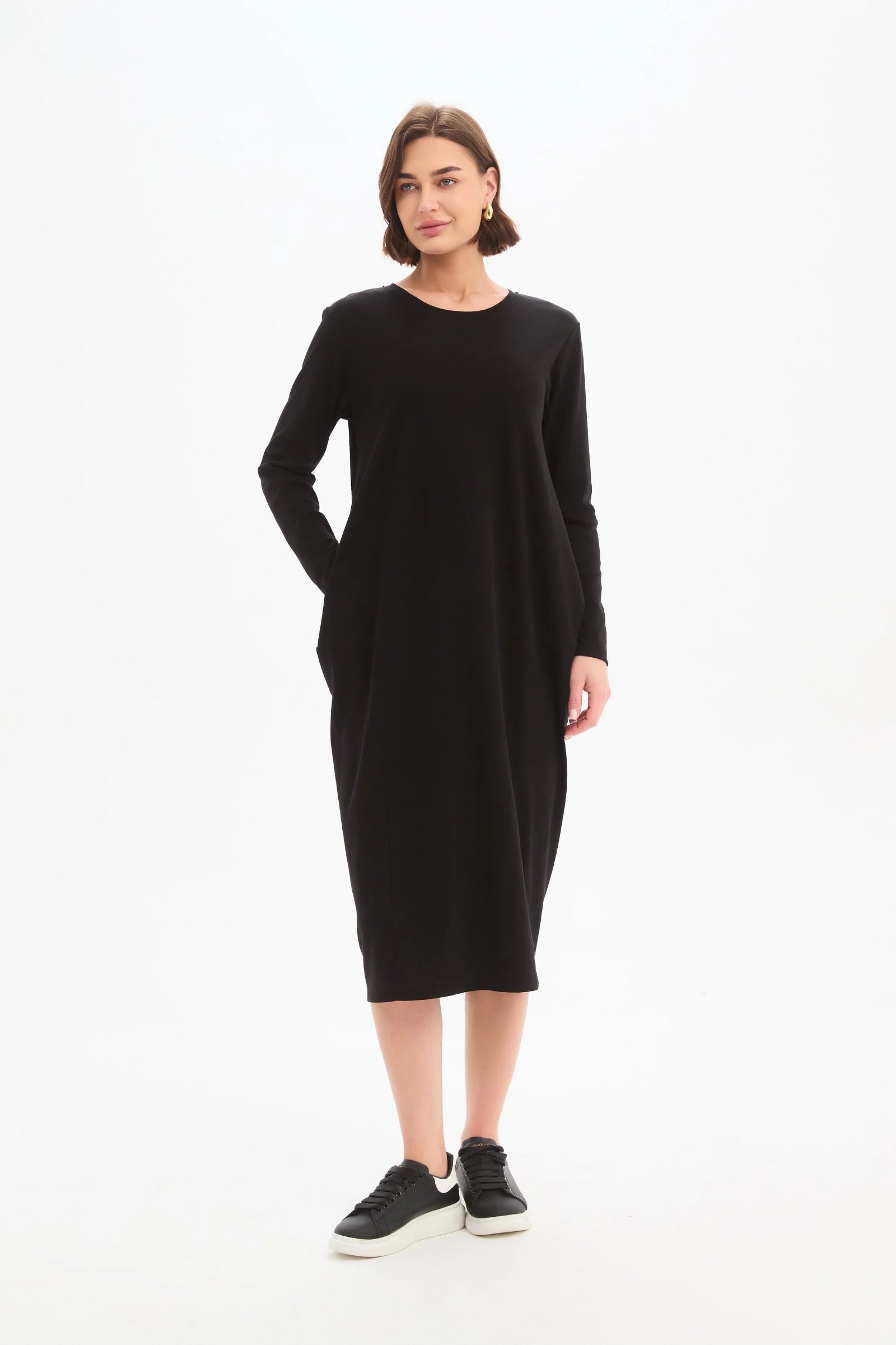 Woman wearing a black dress on a white background