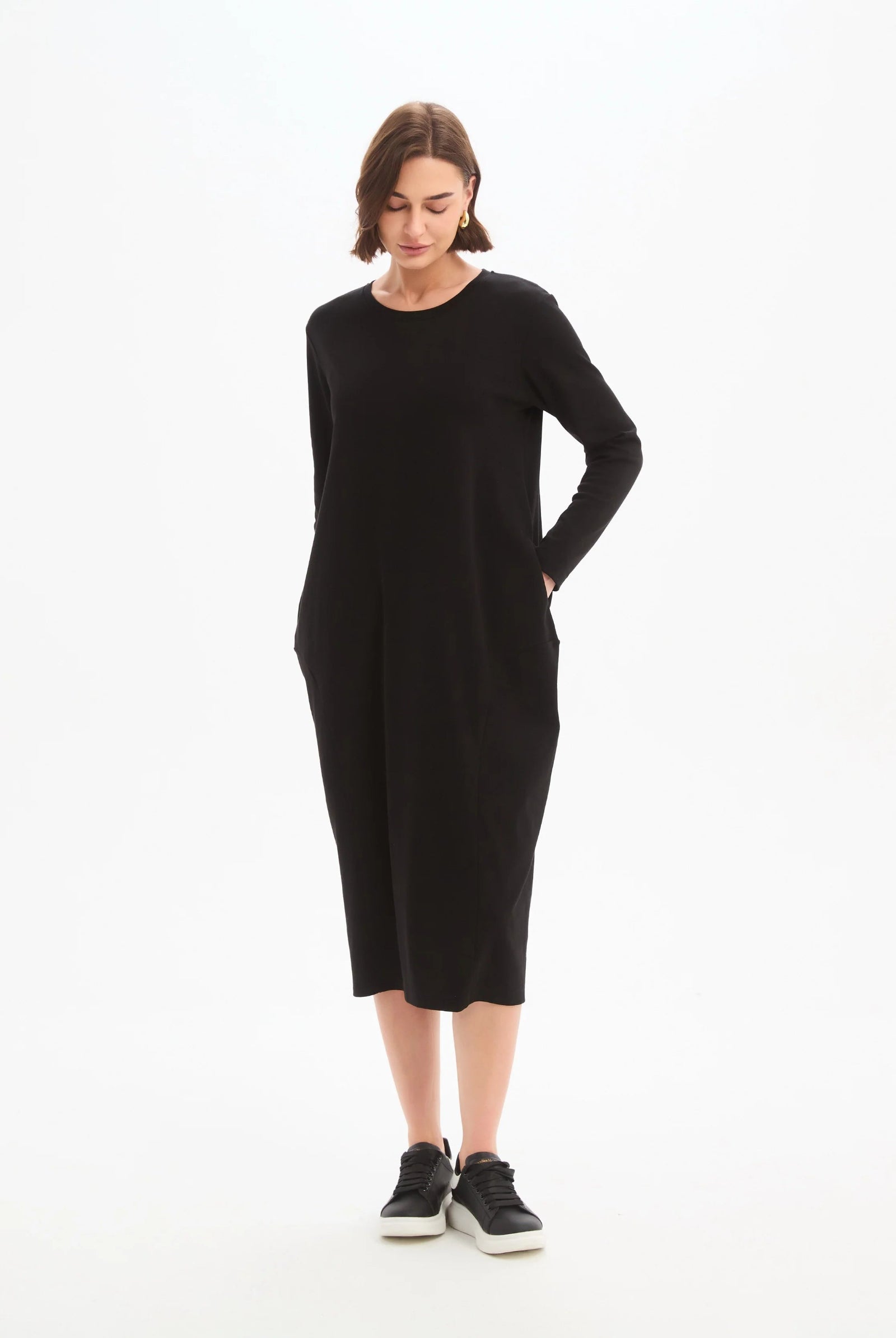 Woman wearing a black dress on a white background