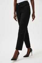 Person wearing black pants on a white background