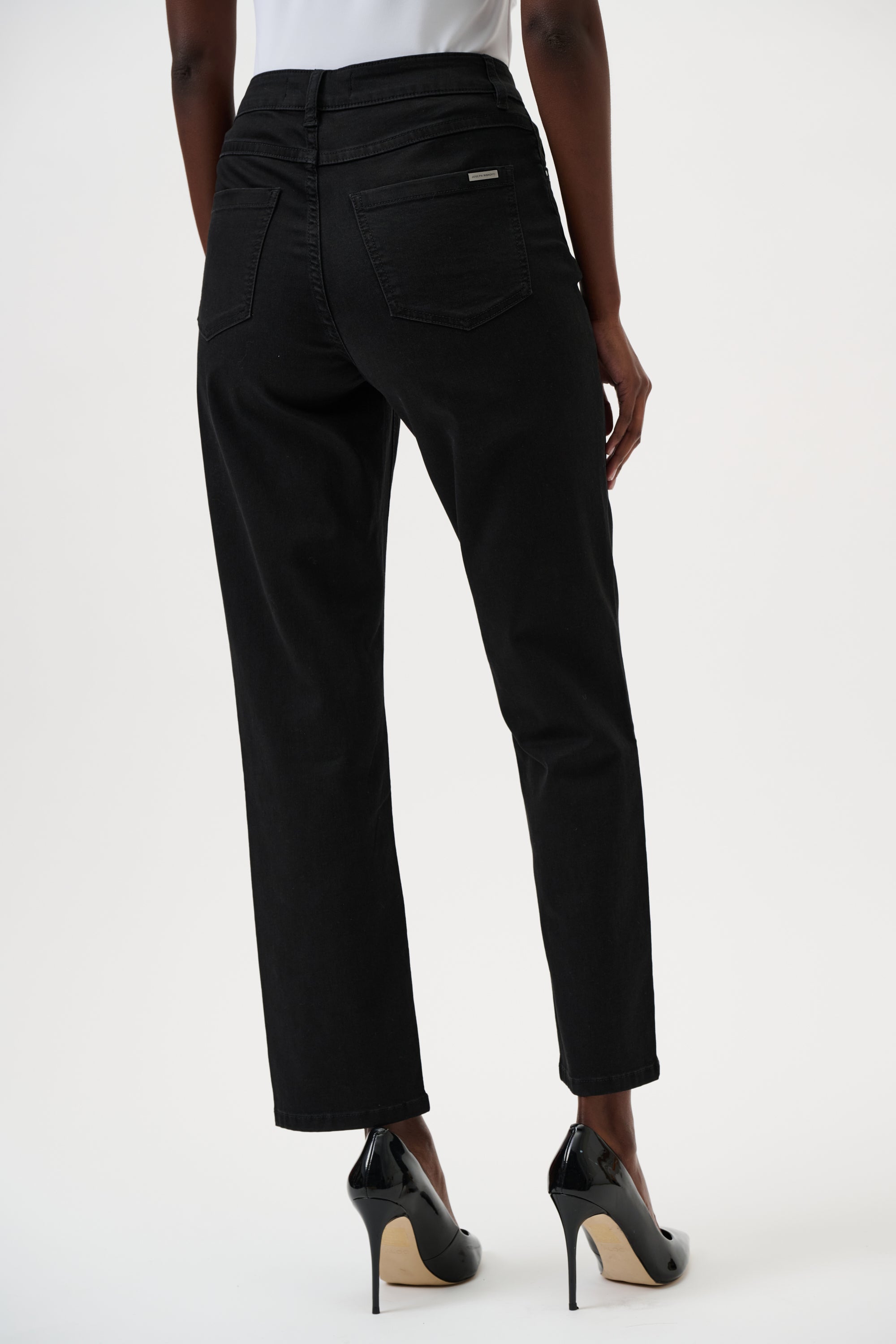 Black pants worn by a person on a white background