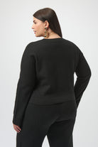 Woman wearing a black outfit on a white background