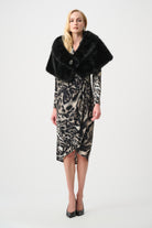Woman wearing a leopard print dress with a black fur shawl on a white background