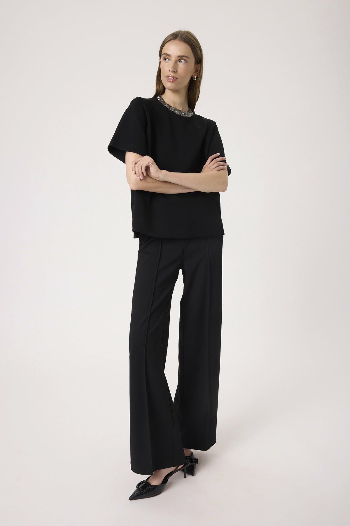 Woman wearing a black outfit on a white background