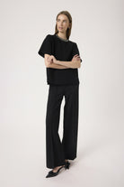 Woman wearing a black outfit on a white background