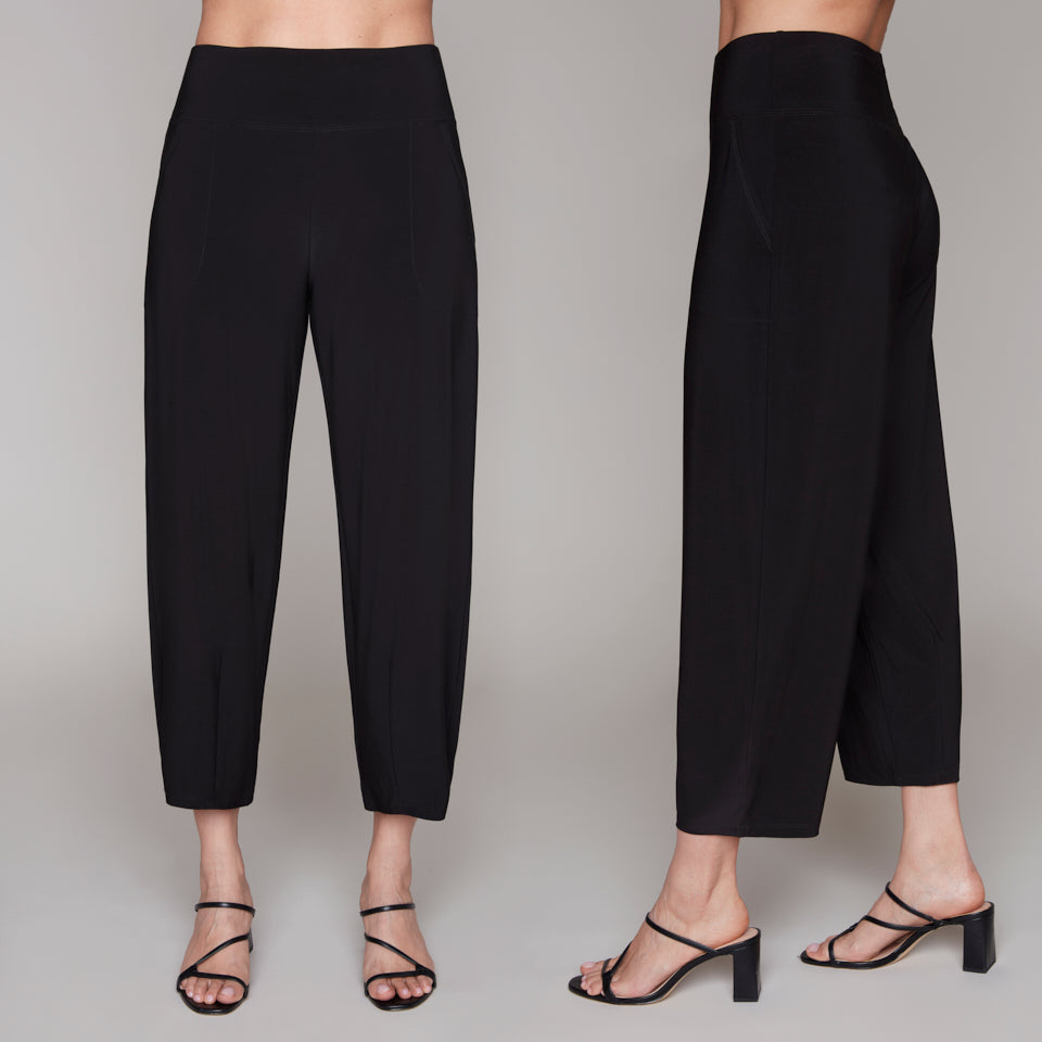 Black pants worn by a person on a plain background