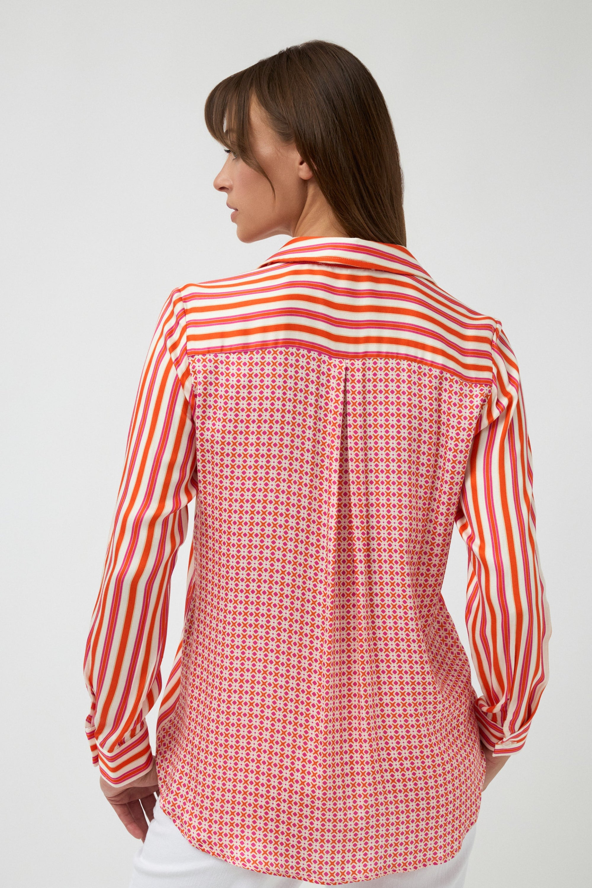 orange pink white stripe button through shirt and white pants worn by model back view