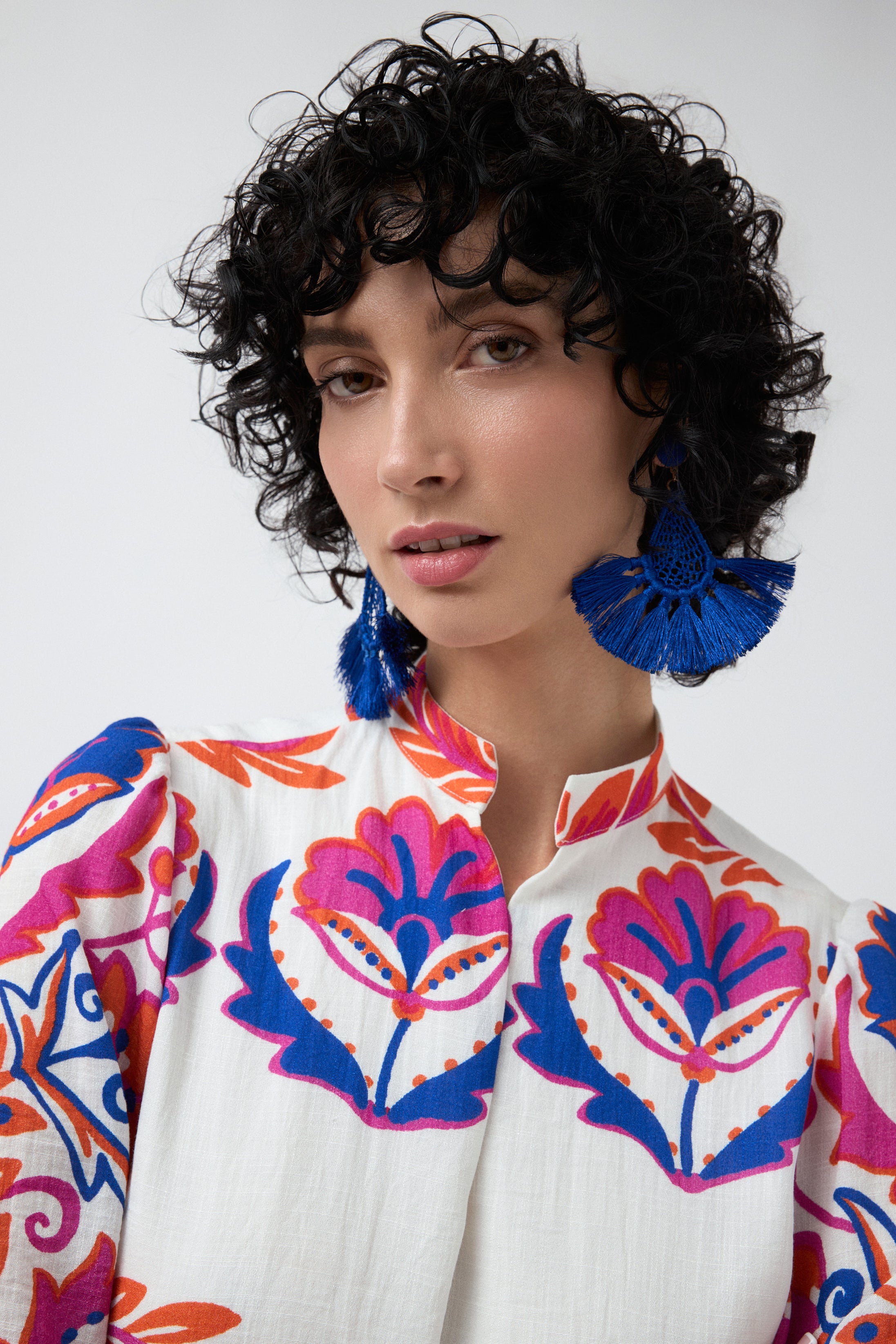 white with pink and blue print shift midi dress worn by model close up