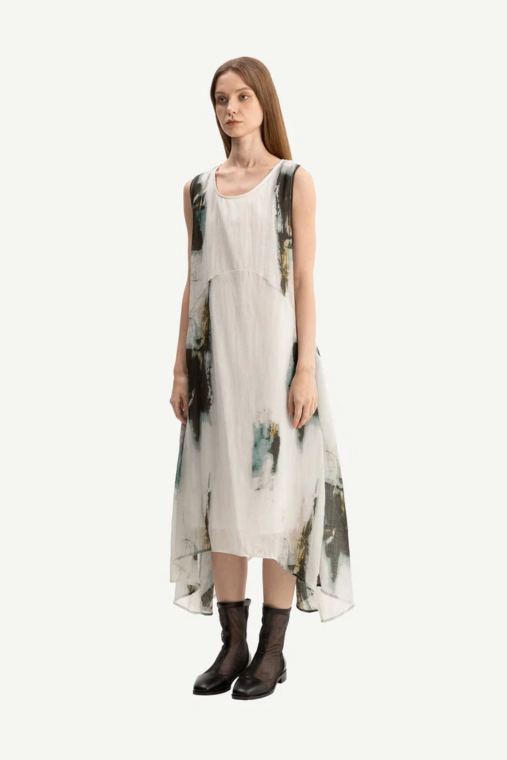 Woman wearing a sleeveless dress with abstract design on a white background