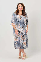 Woman wearing a floral dress on a plain background