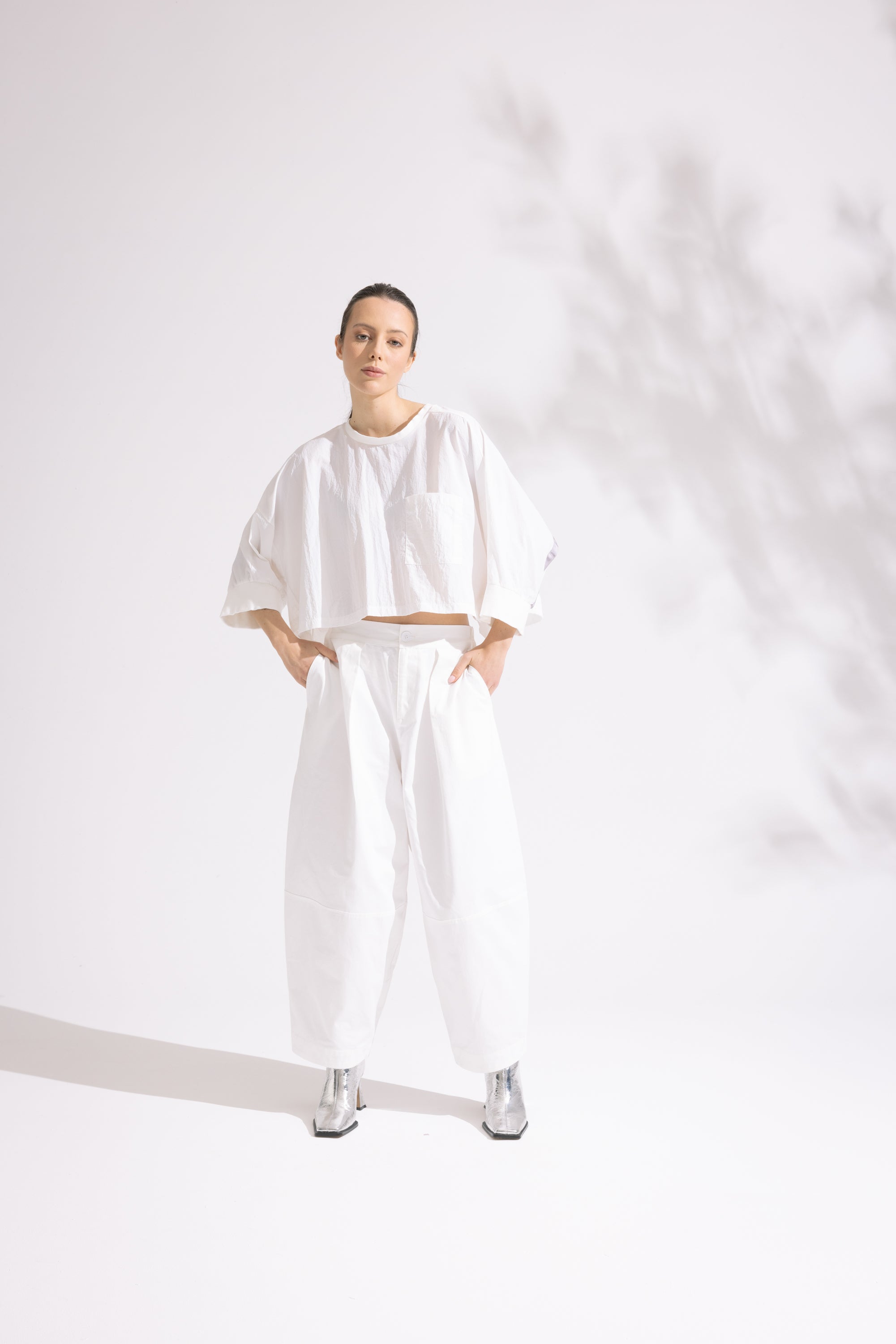 Person wearing a white outfit on a plain background