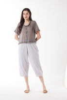 light grey capri pants and grey top worn by model 