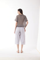 light grey capri pants and grey top worn by model back view