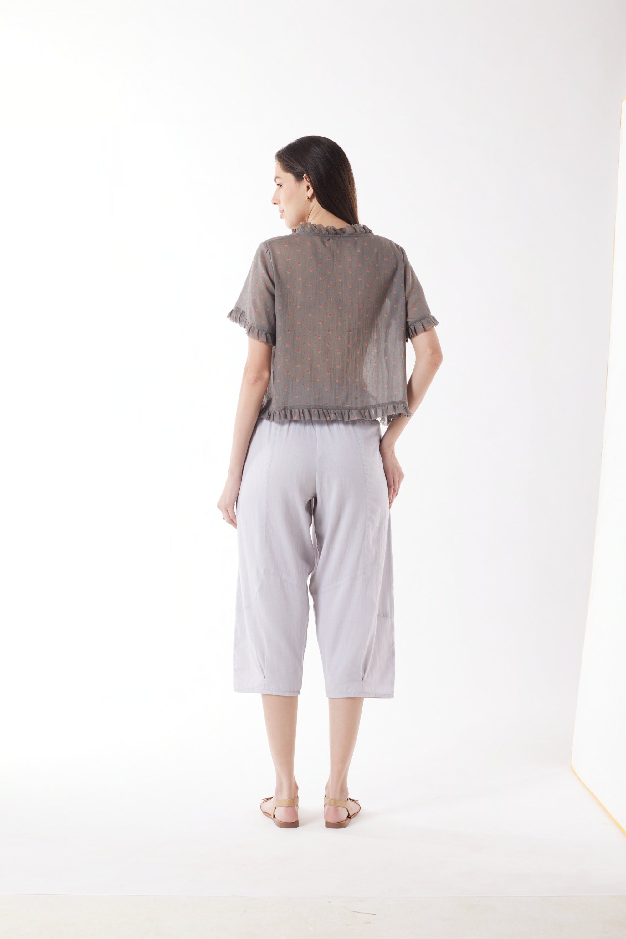 light grey capri pants and grey top worn by model back view