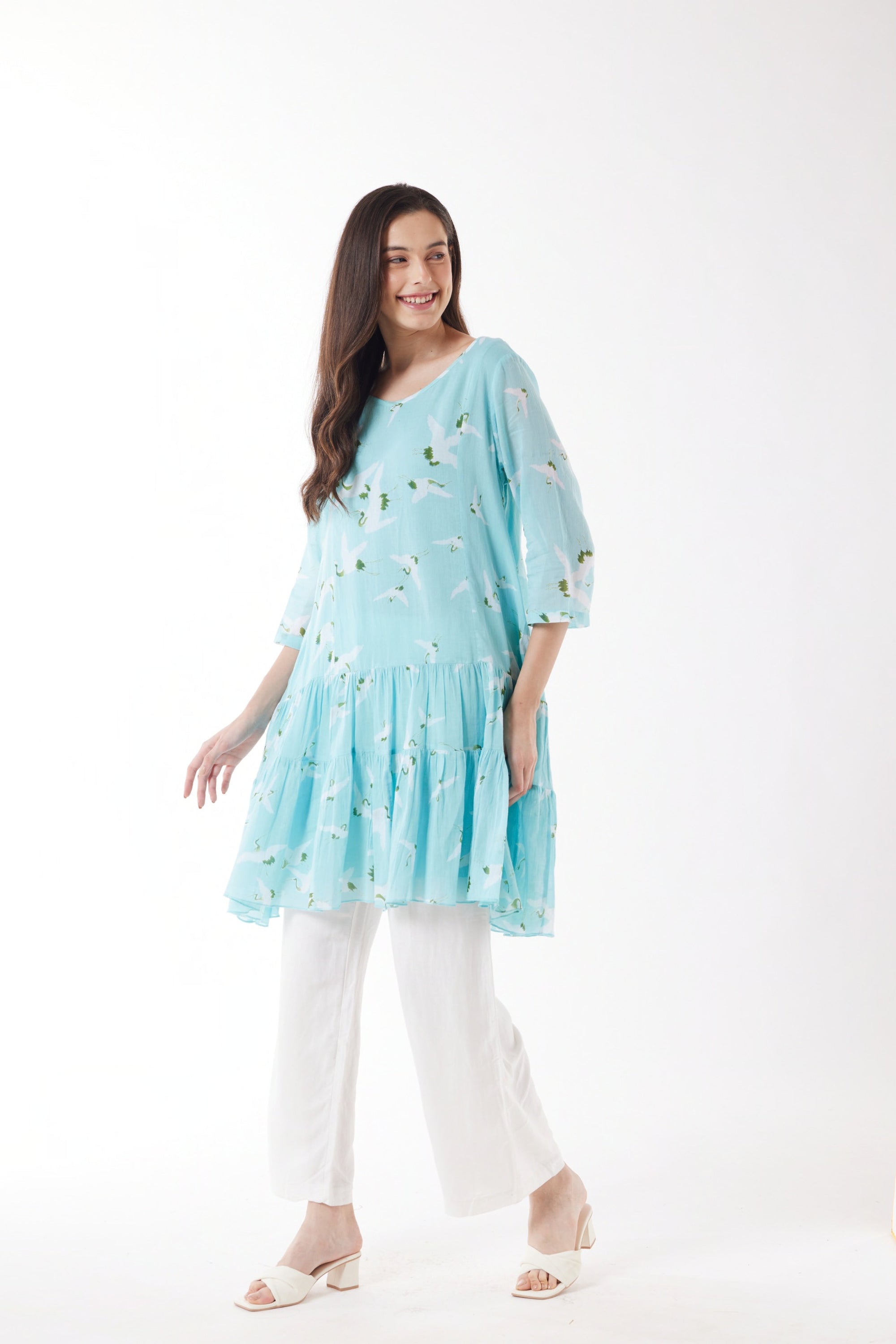 blue with white bird print midi dress with white pants worn by model 