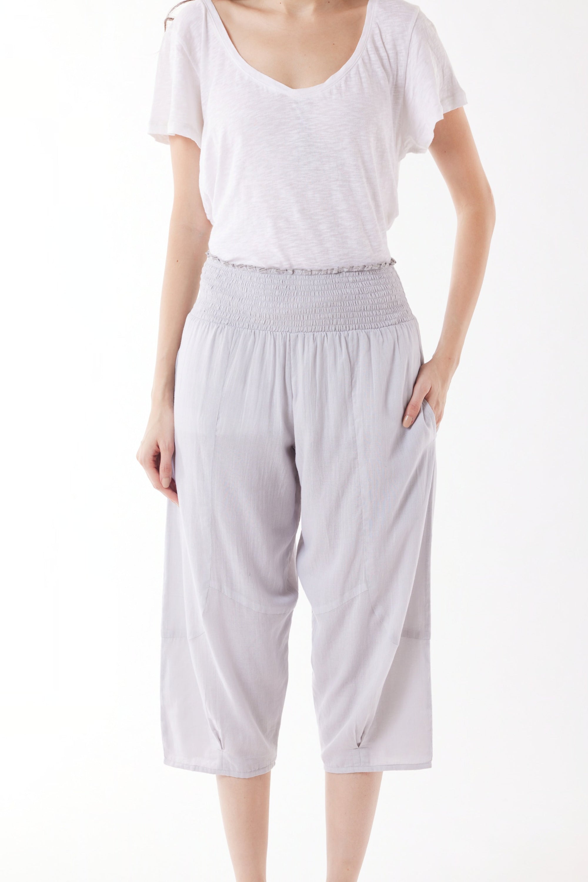 light grey capri pants and white top worn by model 