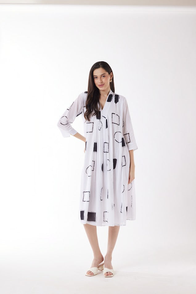 white midi dress with black geo print worn by model 