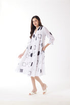 white midi dress with black geo print worn by model 