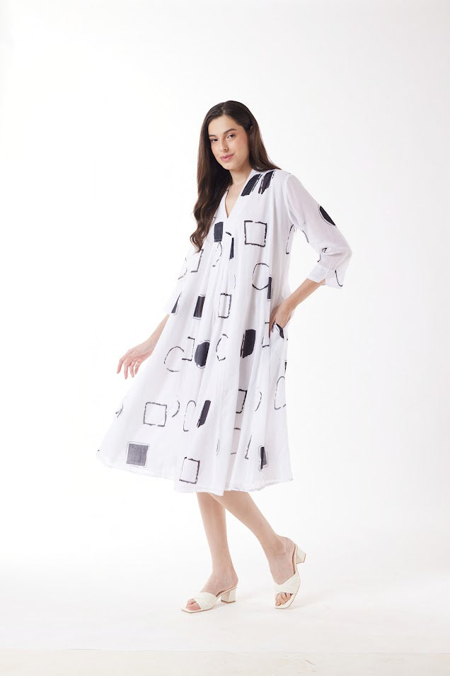 white midi dress with black geo print worn by model 