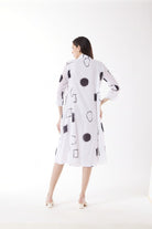 white midi dress with black geo print worn by model back view