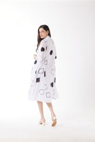 white midi dress with black geo print worn by model back view