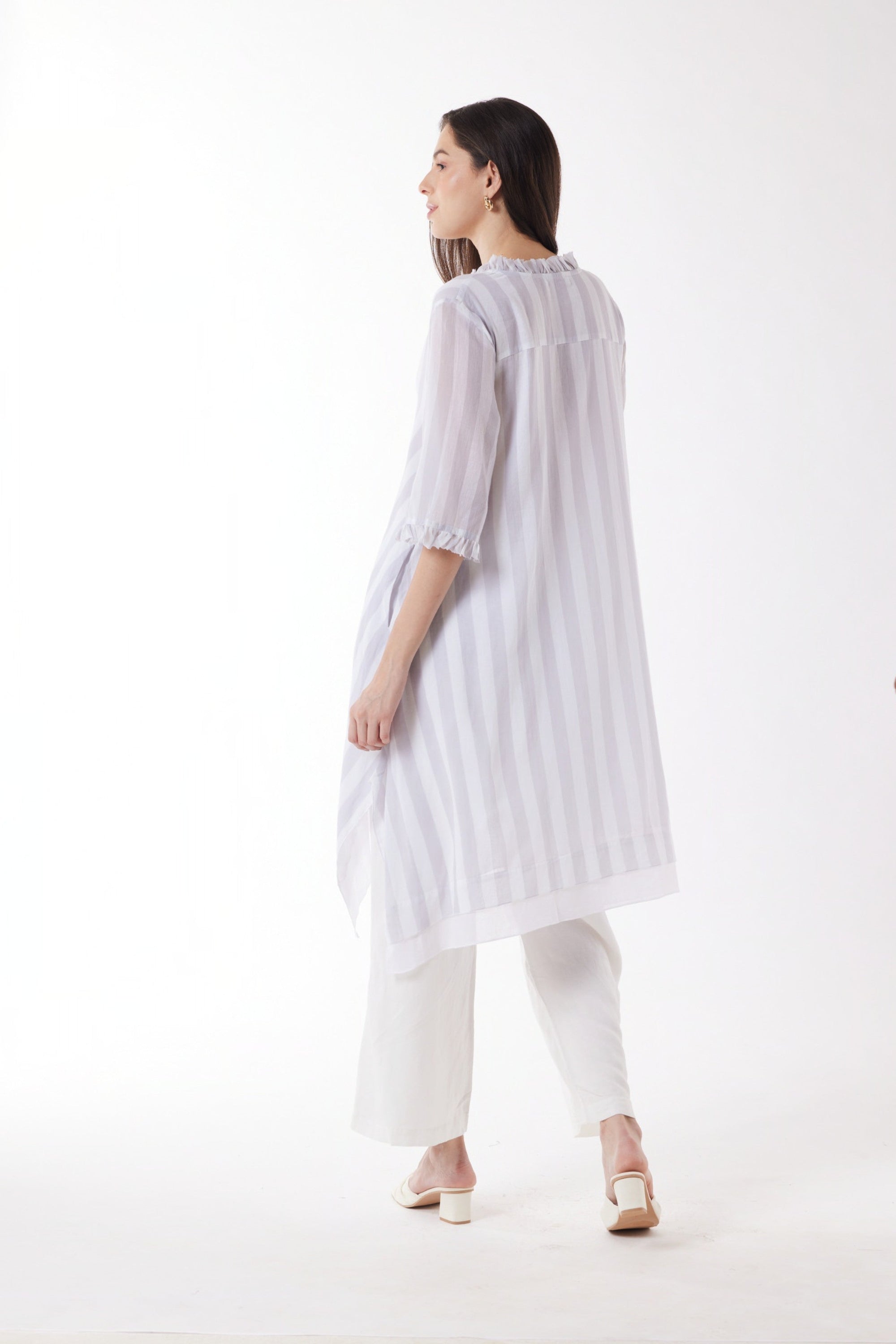 longline white grey stripe shirt and white pants worn by model back view