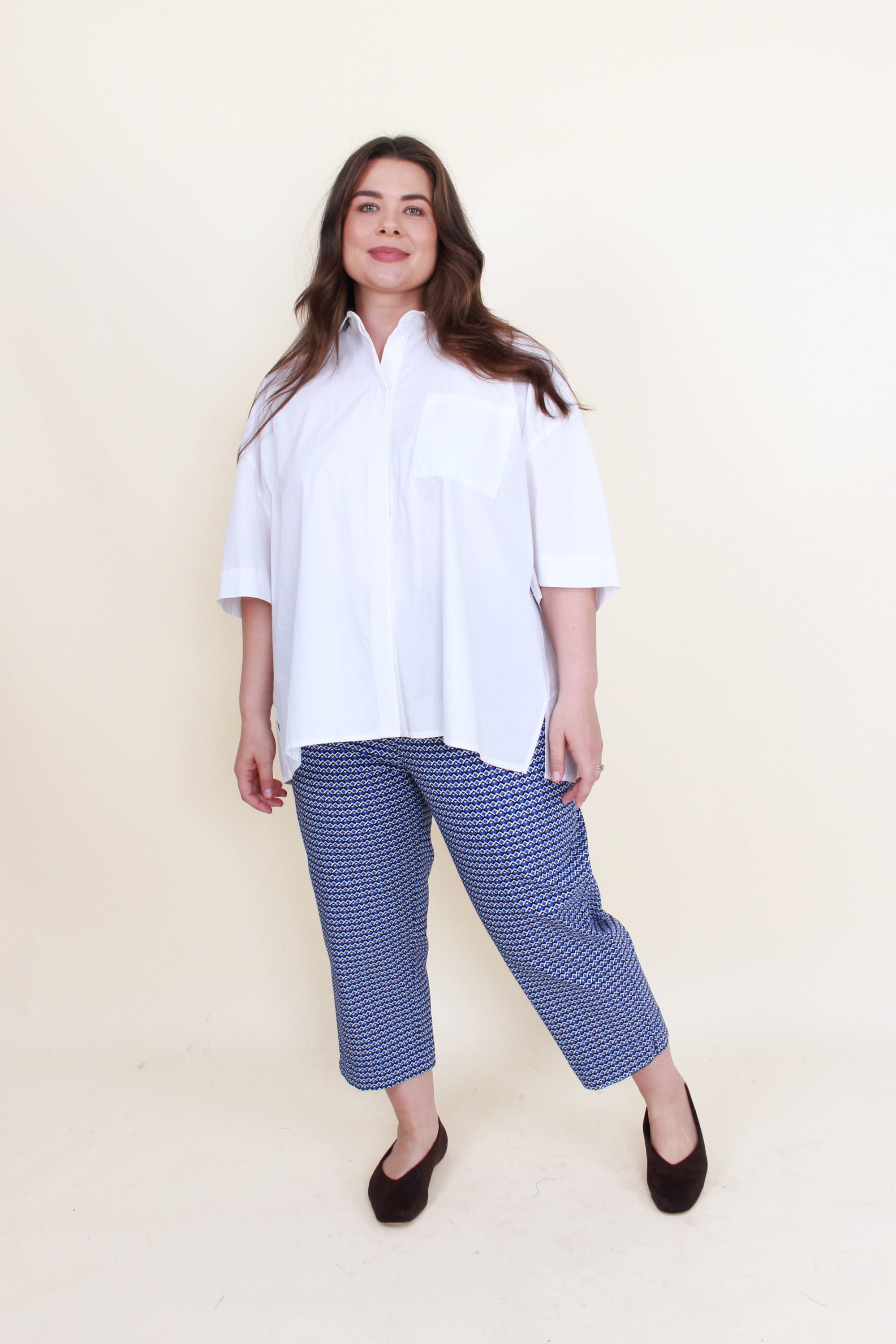 blue and white print 7/8 pants with white top worn by model 