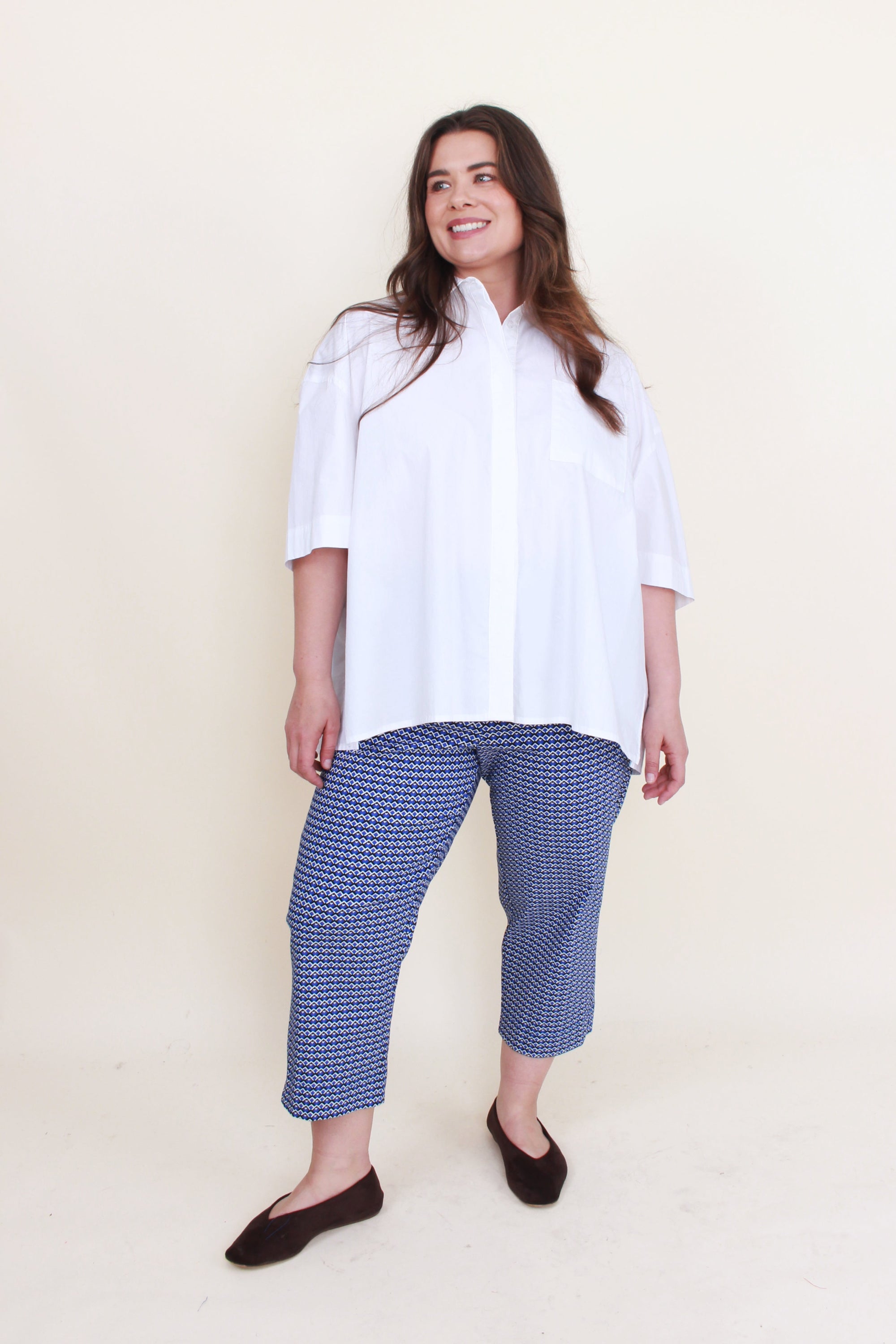 blue and white print 7/8 pants with white top worn by model 