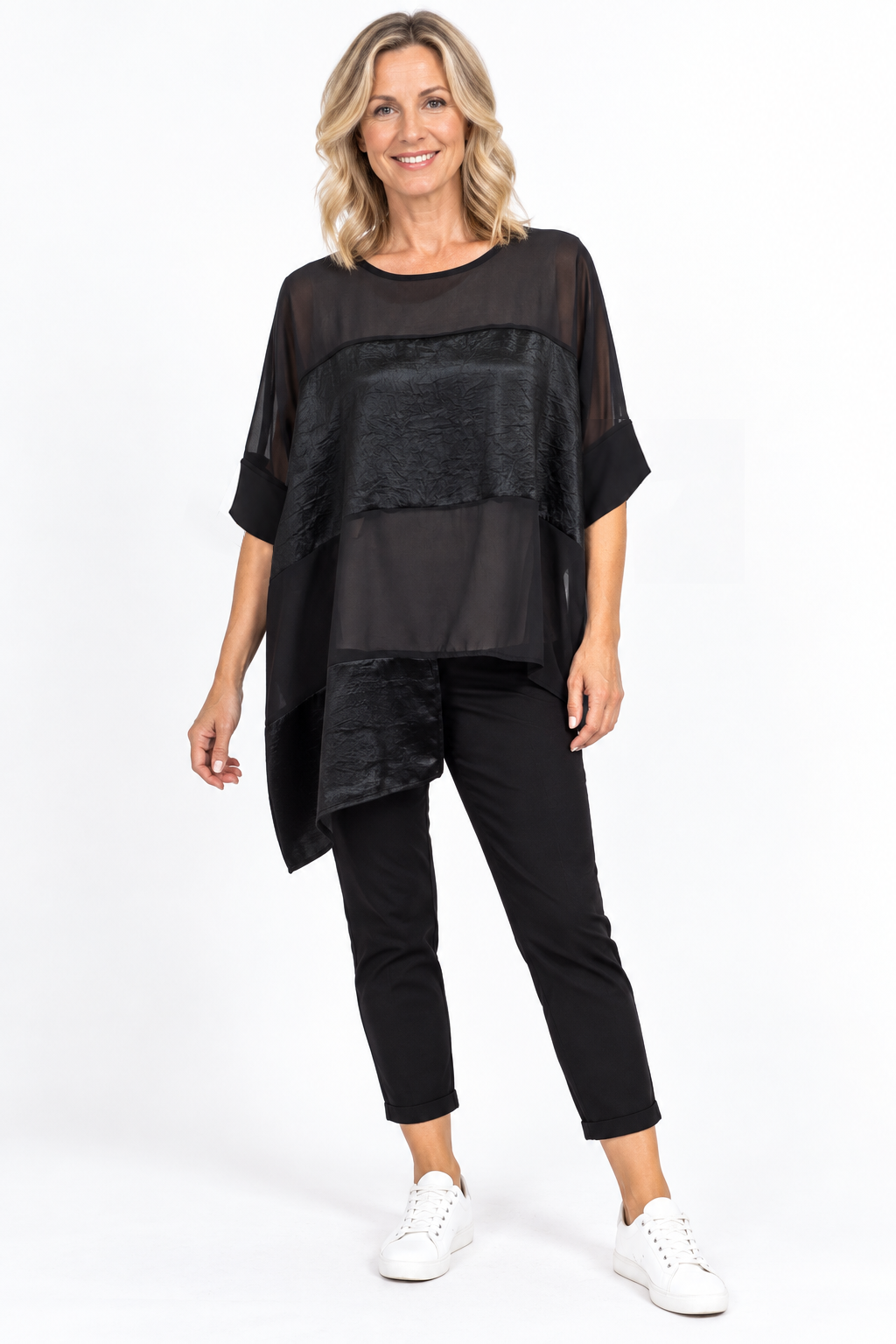 women wearing a black panelled top on a plain background