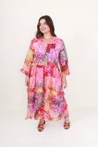 Woman wearing a colorful patchwork dress on a white background