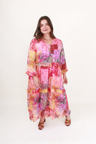 Woman wearing a colorful patchwork dress on a white background